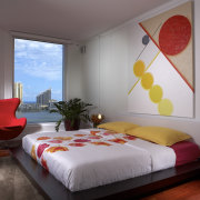 View of bedrrom with yellow and red artwork. bed, bed frame, bed sheet, bedroom, ceiling, home, interior design, real estate, room, suite, wall, window, gray