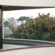 View of home with curved, toughened glass balustrade. architecture, glass, home, house, property, tree, window, white