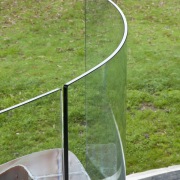 View of home with curved, toughened glass balustrade. grass, lawn, line, plant, tree, green