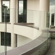 View of home with curved, toughened glass balustrade. architecture, floor, furniture, glass, handrail, interior design, stairs, white