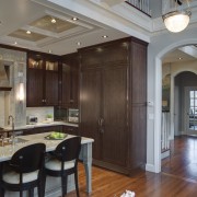 Stainless steel appliances.  Dark walnut surfaces. Custom ceiling, interior design, living room, wood flooring, gray, brown