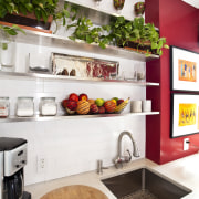 Black porcelain floor tiles. Red accenting walls. Carra countertop, home appliance, interior design, kitchen, shelf, white