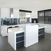 View of kitchen and dining area  designed cabinetry, countertop, cuisine classique, floor, flooring, interior design, kitchen, real estate, white, gray