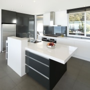 View of kitchen and dining area  designed cabinetry, countertop, cuisine classique, floor, furniture, interior design, kitchen, product design, table, white