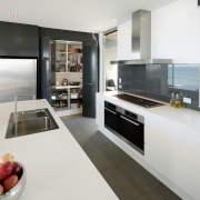 View of kitchen and dining area  designed countertop, home appliance, interior design, kitchen, white