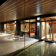 A reflection pool at the front of this architecture, home, house, interior design, lighting, lobby, real estate, brown, black