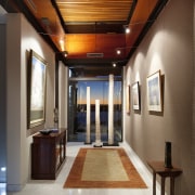 A wide gallery forms a strong axis through ceiling, daylighting, estate, hall, home, interior design, lighting, lobby, real estate, brown, gray