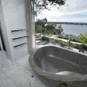 This master suite in a contemporary new house bathtub, estate, property, real estate, gray