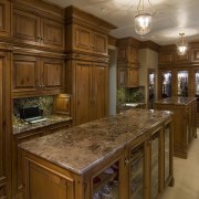 This is a master suite designed by Chuck cabinetry, ceiling, countertop, cuisine classique, estate, floor, flooring, hardwood, home, interior design, kitchen, room, under cabinet lighting, wood flooring, wood stain, brown