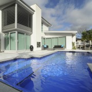 A new pool, by Mayfair pools, featuring a architecture, estate, home, house, property, real estate, swimming pool, villa, gray, blue