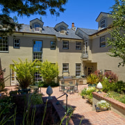 View of patio area of home. - View backyard, cottage, courtyard, estate, facade, home, house, landscaping, mansion, neighbourhood, plant, property, real estate, residential area, suburb, tree, villa, yard, brown, black