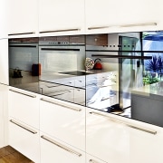 View of kitchen featuring wood floors, white bench cabinetry, countertop, cuisine classique, home appliance, interior design, kitchen, product design, white