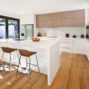 View of kitchen featuring wood floors, white bench cabinetry, countertop, cuisine classique, floor, flooring, hardwood, interior design, kitchen, laminate flooring, real estate, room, wood, wood flooring, white
