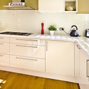 View of kitchen featuring wood floors, white bench cabinetry, countertop, cuisine classique, floor, flooring, hardwood, interior design, kitchen, product design, room, orange