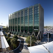 Novotel Hotel, Auckland Airport. The handles on doors architecture, building, city, condominium, corporate headquarters, daytime, headquarters, metropolitan area, mixed use, reflection, sky, structure, urban area, water, teal