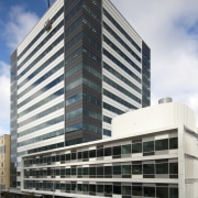 View of the exterior of the Vogel Center apartment, architecture, building, city, commercial building, condominium, corporate headquarters, daytime, facade, headquarters, metropolis, metropolitan area, mixed use, real estate, residential area, sky, skyscraper, tower block, urban area, gray, black