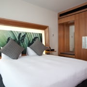 View of a guest room in the Novotel bedroom, hotel, interior design, real estate, room, suite, white, brown