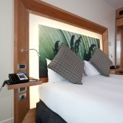 View of a guest room in the Novotel bed, bed frame, bedroom, ceiling, floor, furniture, home, interior design, real estate, room, suite, wall, window, wood, gray, white