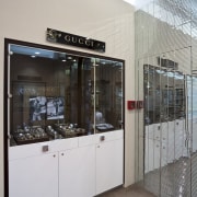 View of the Anna Webster Jeweler boutique.Features repeating glass, interior design, gray