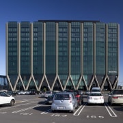 View of the Novotel Auckland Airport in Auckland architecture, building, car, city, commercial building, condominium, corporate headquarters, daytime, facade, headquarters, infrastructure, landmark, luxury vehicle, metropolis, metropolitan area, mixed use, parking, parking lot, sky, tower block, urban area, teal