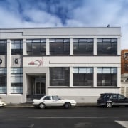 View of the former Woollen Mills factory, now architecture, building, car, commercial building, corporate headquarters, facade, family car, luxury vehicle, mixed use, real estate, vehicle, black