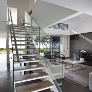 This house was designed by Hamish Cameron NZIA architecture, condominium, handrail, house, interior design, living room, real estate, stairs, gray