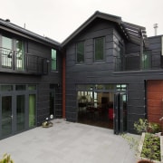 This house was designed by Gina Jones of architecture, building, facade, home, house, property, real estate, residential area, siding, window, black, white