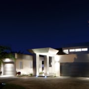 This house was designed and built by Signature architecture, building, darkness, estate, facade, home, house, landscape lighting, light, lighting, night, property, real estate, residential area, sky, blue, black