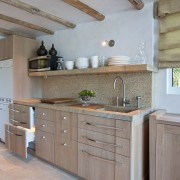 This homes' kitchen was designed by Mick De cabinetry, countertop, cuisine classique, floor, flooring, hardwood, home, interior design, kitchen, room, wall, wood, wood flooring, gray