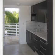 This homes' kitchen was designed by Mick De cabinetry, countertop, floor, interior design, kitchen, real estate, room, sink, gray, black