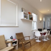 This home was renovated by Tse:Wallace Architects. Here ceiling, chair, daylighting, floor, flooring, furniture, hardwood, home, house, interior design, laminate flooring, living room, real estate, room, table, wood, wood flooring, gray