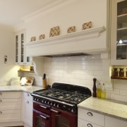 This kitchen was designed by Debra DeLorenzo of cabinetry, countertop, cuisine classique, floor, flooring, home appliance, interior design, kitchen, kitchen appliance, kitchen stove, room, orange