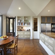 View of dining area in home by Stonehaven countertop, cuisine classique, floor, flooring, hardwood, home, interior design, kitchen, property, real estate, room, window, wood flooring, gray