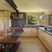 This home and kitchen was designed by Finne countertop, house, interior design, kitchen, real estate, room, window, brown, orange