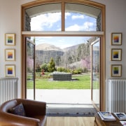 This home in Queenstown was renovated by architect daylighting, door, estate, furniture, home, house, interior design, living room, real estate, room, table, window, wood, gray