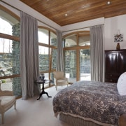 Bedroom with light toned flooring and walls, wooden bedroom, ceiling, estate, interior design, property, real estate, room, window, wood, gray