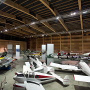 Here is a view of MOTAT's Arviation Display automotive design, car, hangar, black, brown