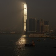 Here is a view of the ICC (International atmosphere, body of water, calm, city, cityscape, dawn, daytime, dusk, evening, haze, horizon, metropolis, morning, night, reflection, river, sea, sky, skyline, skyscraper, sunset, tower, tower block, water, waterway, black