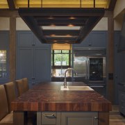 View of kitchen, great room and wine cellar. architecture, cabinetry, ceiling, countertop, cuisine classique, daylighting, home, interior design, kitchen, lighting, under cabinet lighting, wood, brown, black