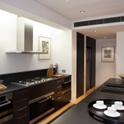 View of contemporary kitchen with dark toned cabinetry interior design, kitchen, real estate, room, gray, black