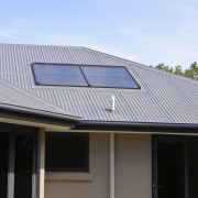 This large home efficiently uses solar energy thanks daylighting, facade, house, roof, siding, solar energy, solar panel, solar power, window, gray, black