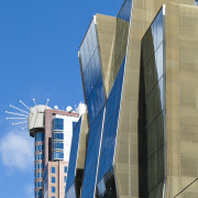 Here is a view of the new Telecom architecture, building, city, commercial building, condominium, corporate headquarters, daytime, facade, headquarters, landmark, metropolis, metropolitan area, sky, skyscraper, tower, tower block, urban area, teal