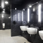 Merquip designed the electronic touch-free tap-ware for this bathroom, ceiling, floor, flooring, interior design, plumbing fixture, public toilet, room, tile, toilet, black, gray