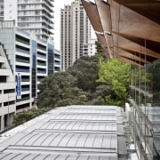 Here is a view of the roof on apartment, architecture, building, condominium, daylighting, daytime, facade, house, line, metropolitan area, outdoor structure, residential area, roof, structure, urban area, window, white