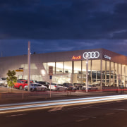 This Audi terminal was built chiefly by Dominion building, car, city, downtown, evening, metropolitan area, mixed use, night, sky, blue, red