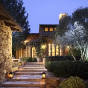 View of steps up to entrance way of architecture, cottage, courtyard, estate, evening, facade, hacienda, home, house, landscape, landscape lighting, landscaping, lighting, mansion, outdoor structure, property, real estate, residential area, sky, villa