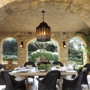 View of dining area with stone walls and estate, hacienda, brown