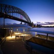 Seen here is a new building on the architecture, bridge, cityscape, dawn, dusk, evening, fixed link, horizon, lighting, night, reflection, sky, structure, sunset, water, blue, black