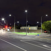 Here is a view of LED, energy-efficient street asphalt, atmosphere of earth, car, city, downtown, evening, infrastructure, lane, light, light fixture, lighting, metropolitan area, night, road, sky, street, street light, traffic, tree, urban area, black, gray