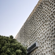 This precinct was developed by Mirvac. Here is architecture, building, facade, roof, sky, tree, wall, white, gray